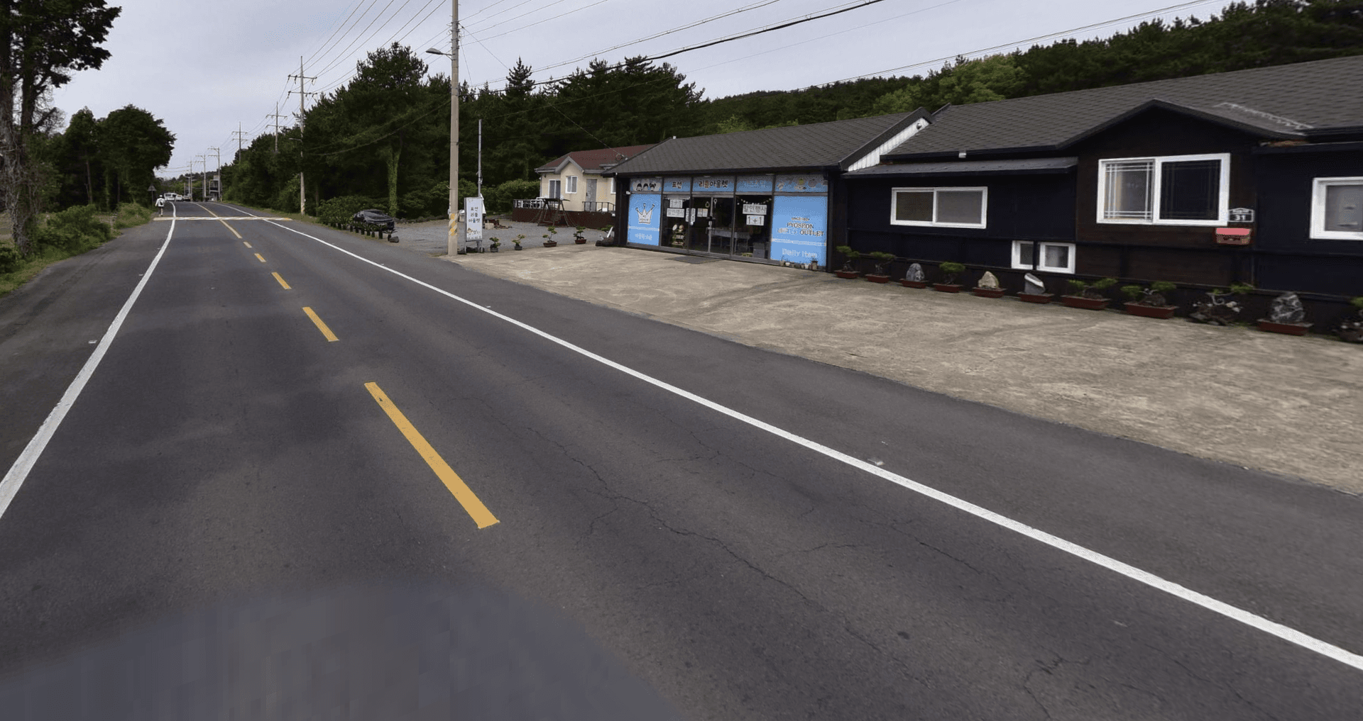Building exterior — road view with parking lot