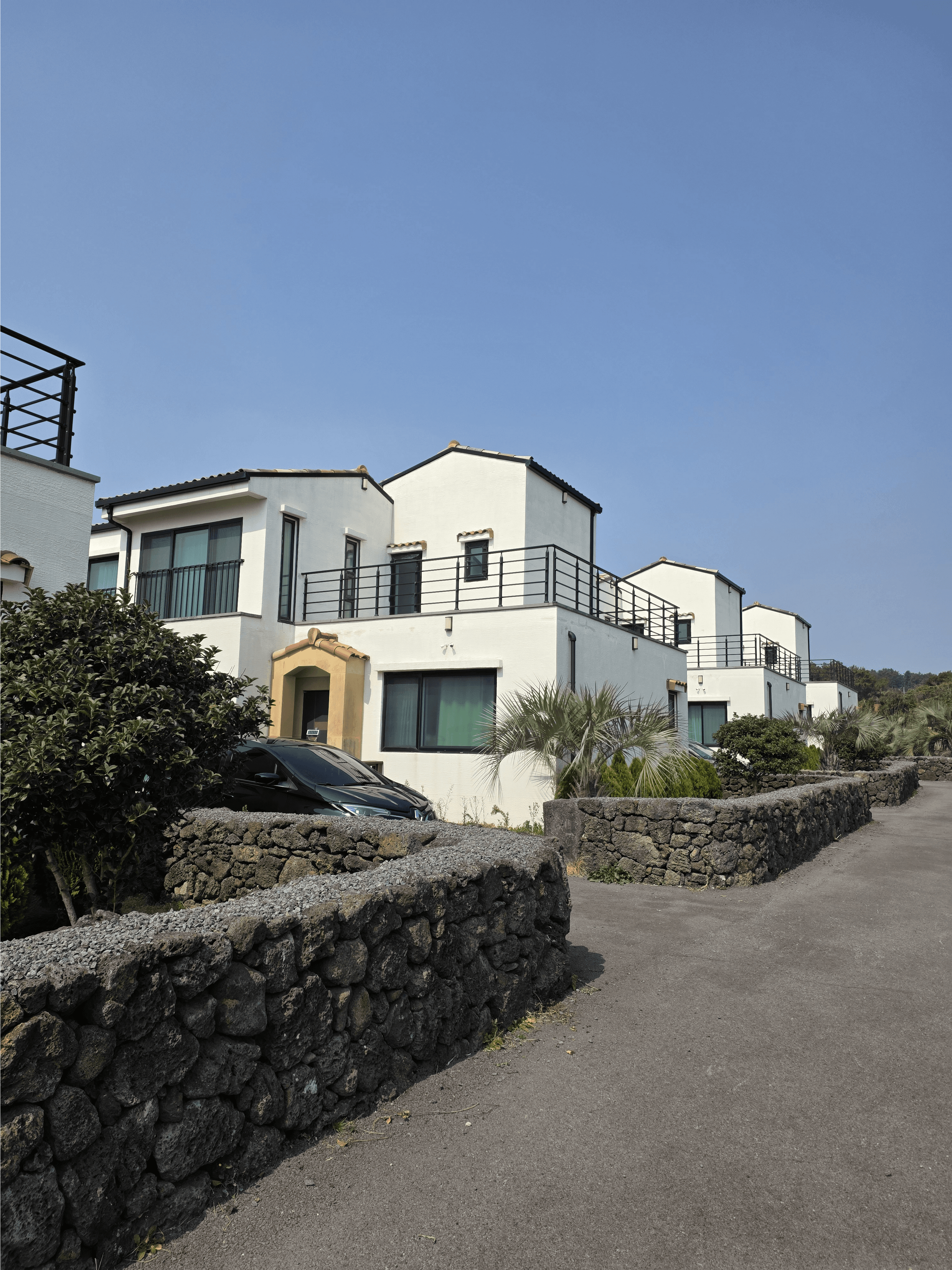 Villa exterior with traditional Jeju stone walls