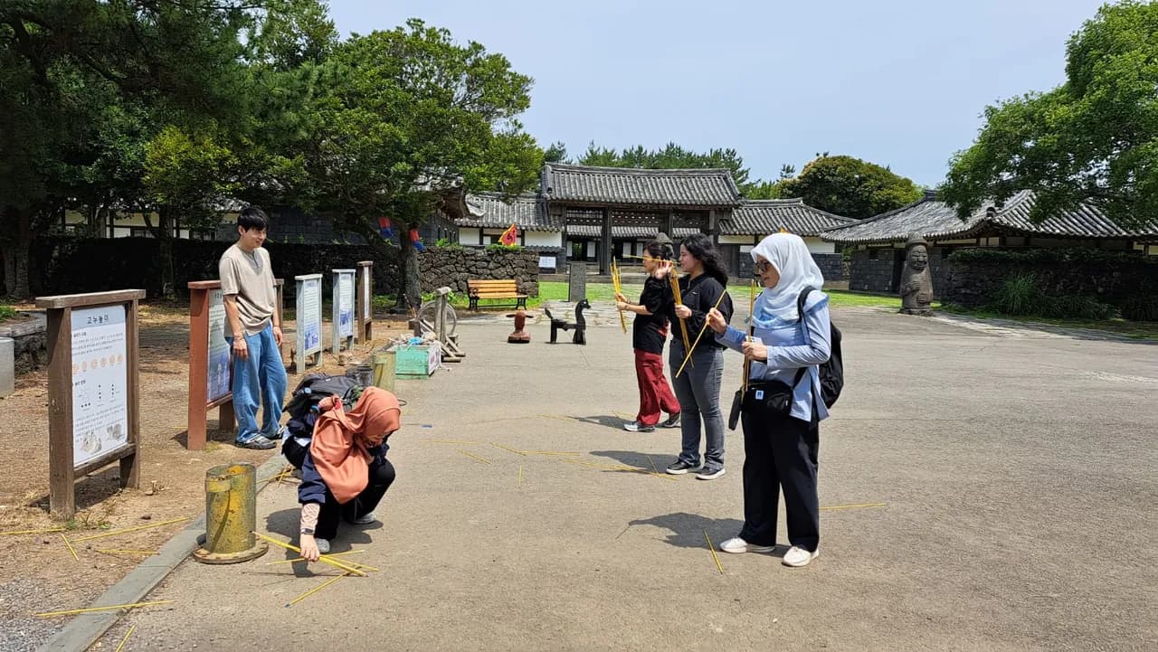 Playing a traditional Korean folk game in the village courtyard