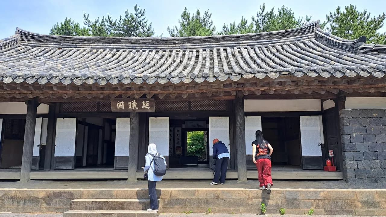 A thatched-roof stone house at the Jeju folk village