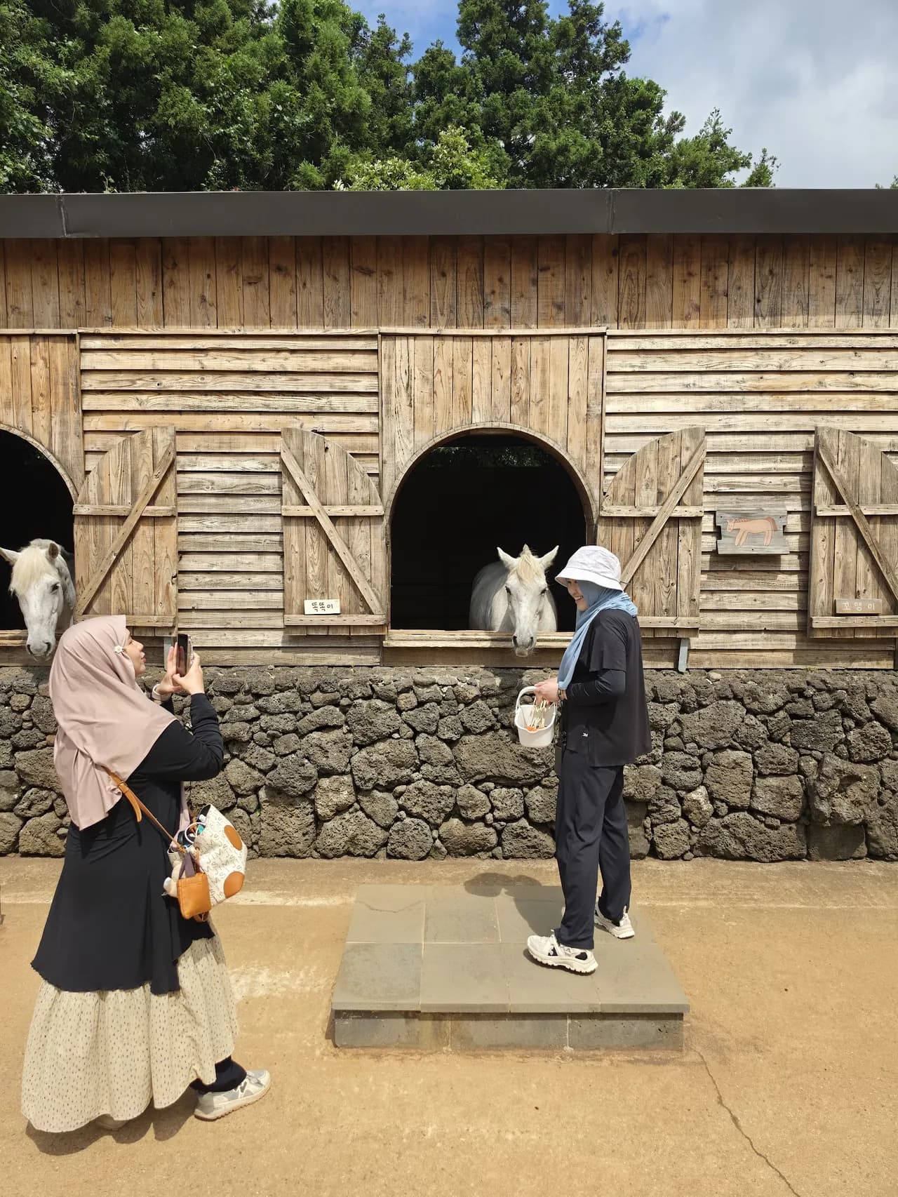 Posing beside the old stone kilns at the folk village