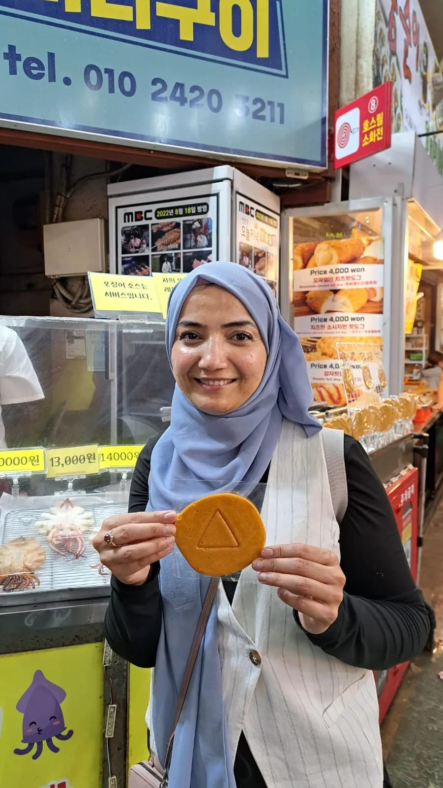 A guest smiling with an ice cream cone at the shop
