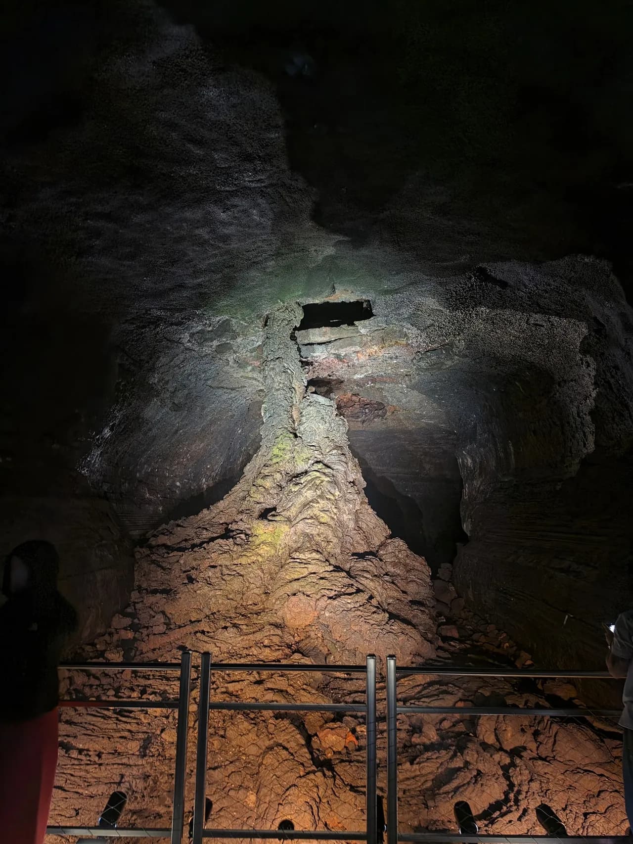 The lit interior path of a Jeju lava tube
