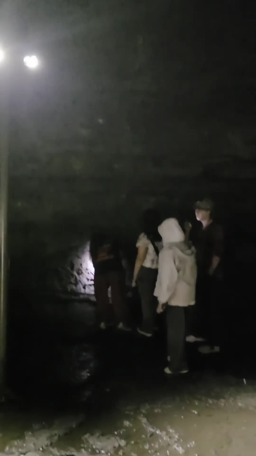 Walking deeper into the dark lava-tube cave