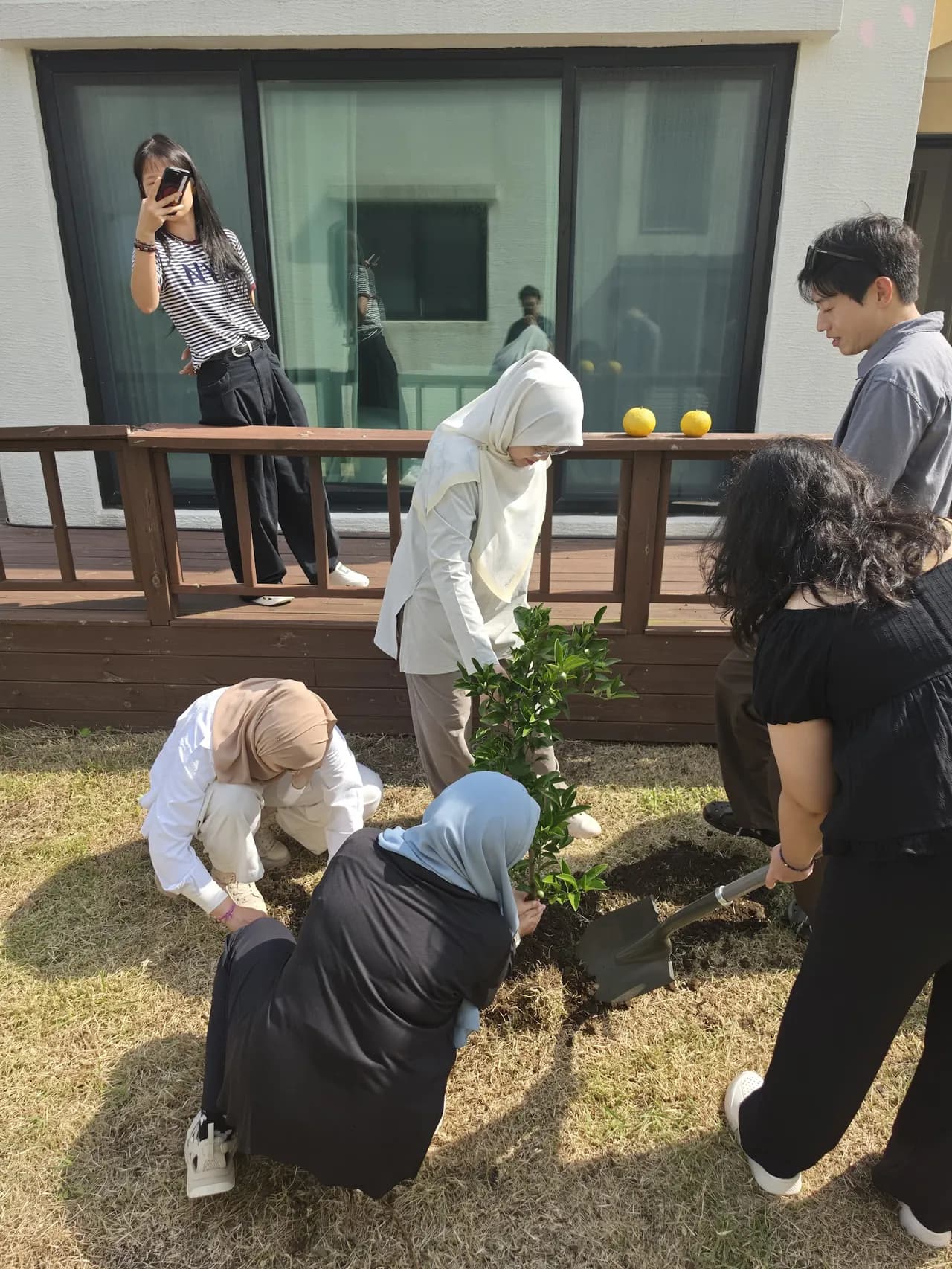 Planting the Sadaqah Jariyah tangerine tree on the villa deck